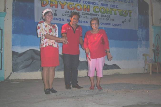 Brgy. Captain Carmelita U. Casana received the cash prize of P3,000.00 as 1st prize winner of the Barangay Daygon Contest from Mayor Esma and Mrs. Conching Esma, mother of the mayor, representing the major sponsor which was Engr.  Rene G. Esma.