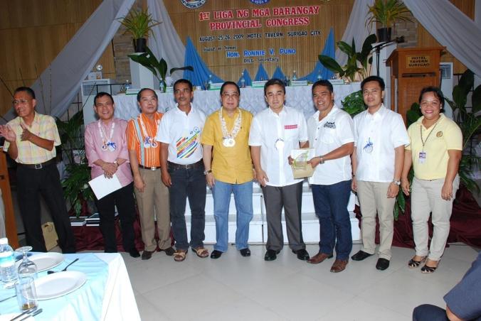 Hon. Mayor Dominador G. Esma, Jr. and Hon. ABC President Ferdinand L. Angob, Barangay Captain of Julio Ouano, Alegria, Surigao del Norte received from Hon. Governor Robert Ace S. Barbers the plaque of recognition and cash award of P 10,000.00 as DILG Secretary Ronnie Puno, Congressmen Romarate and Matugas witnessed the awarding on August 26, 2009 at the Provincial Convention Center, Capitol, Surigao City during the 1st Liga Ng Mga Barangay Congress sponsored by the two congress legislators in coordination with Prov’l. DILG Office and Surigao del Norte Provincial Government.